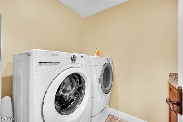 laundry room with cabinets, separate washer and dryer, and light tile patterned floors