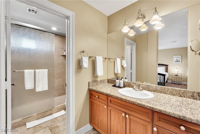 bathroom featuring vanity, tile patterned floors, and a shower with door