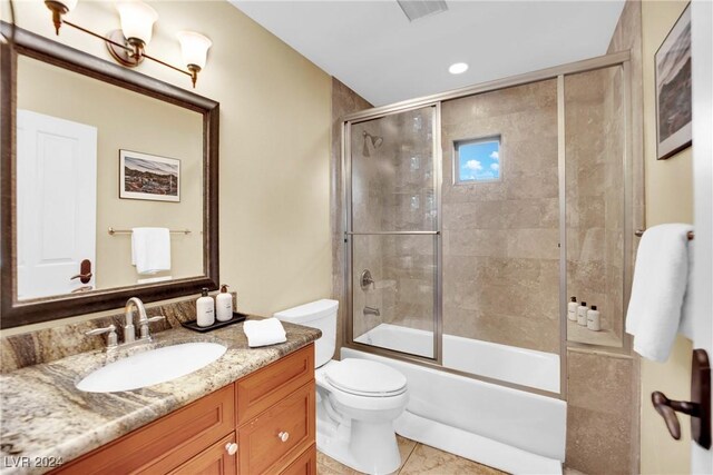 full bathroom featuring vanity, toilet, enclosed tub / shower combo, and tile patterned flooring