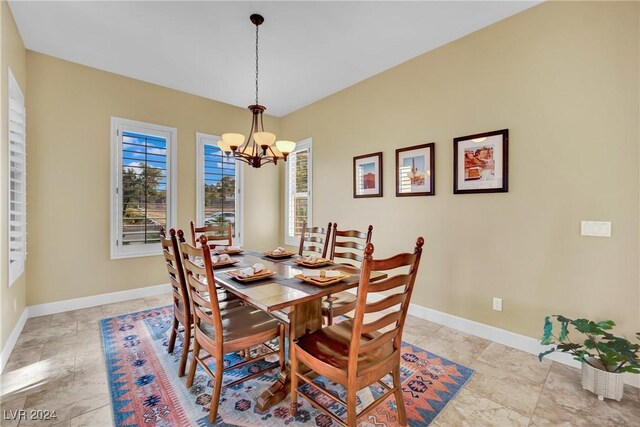 dining space featuring an inviting chandelier