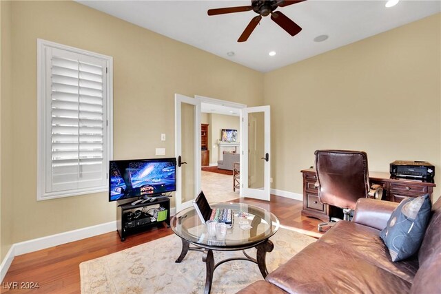 living room featuring ceiling fan, wood-type flooring, and french doors