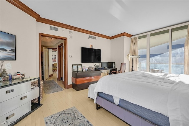 bedroom featuring light hardwood / wood-style floors and crown molding