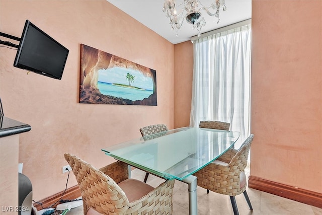 dining space with a wealth of natural light and a chandelier