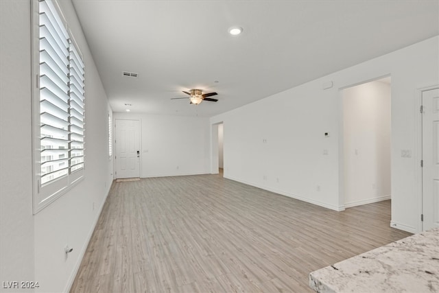 unfurnished living room with ceiling fan and hardwood / wood-style floors