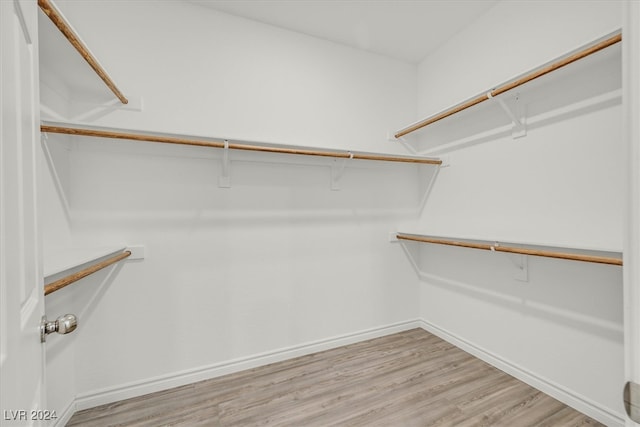 walk in closet featuring light hardwood / wood-style flooring