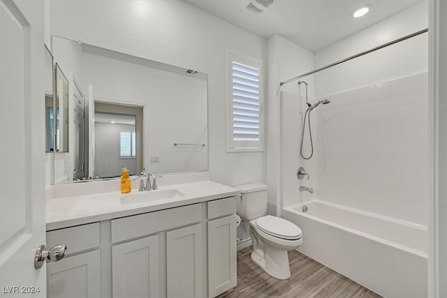 full bathroom with wood-type flooring, toilet, shower / washtub combination, and vanity