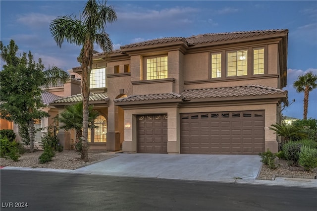 mediterranean / spanish-style house featuring a garage