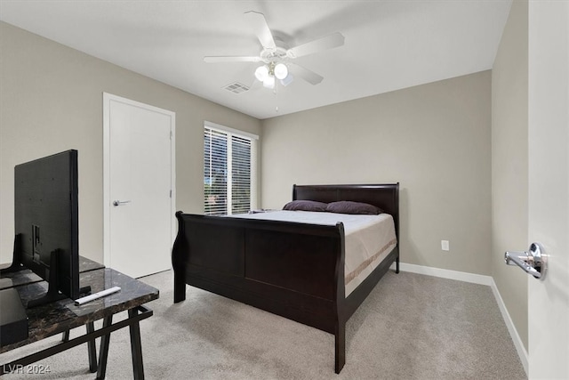 bedroom with light carpet and ceiling fan