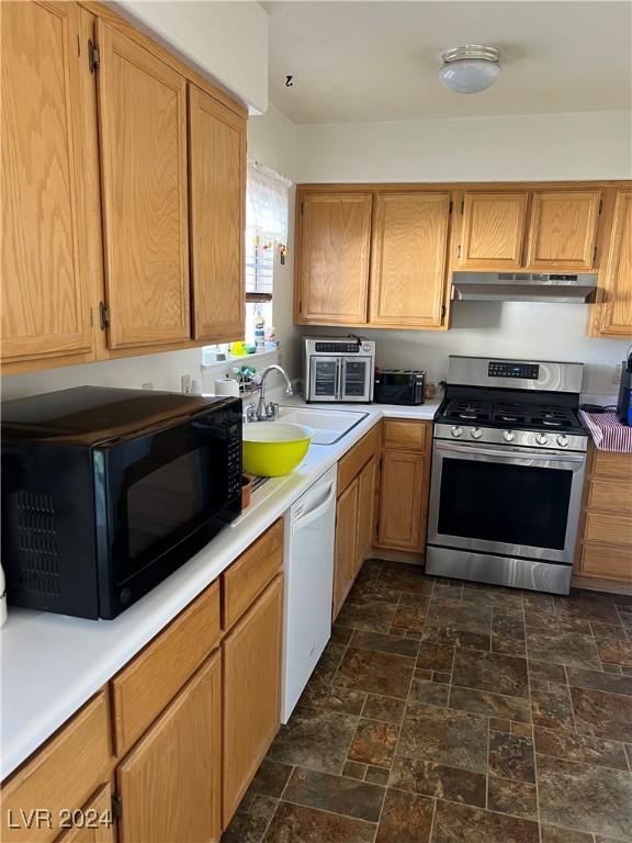 kitchen with white dishwasher, a sink, stainless steel gas range, black microwave, and under cabinet range hood