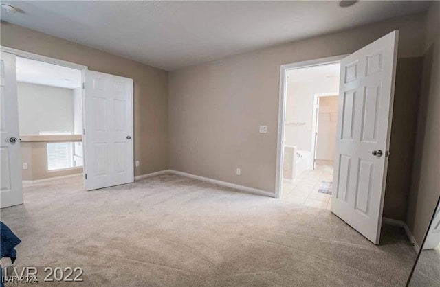 unfurnished bedroom featuring light colored carpet