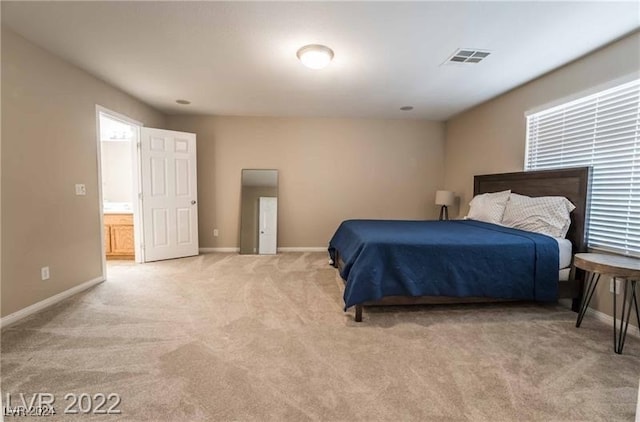 carpeted bedroom with ensuite bathroom