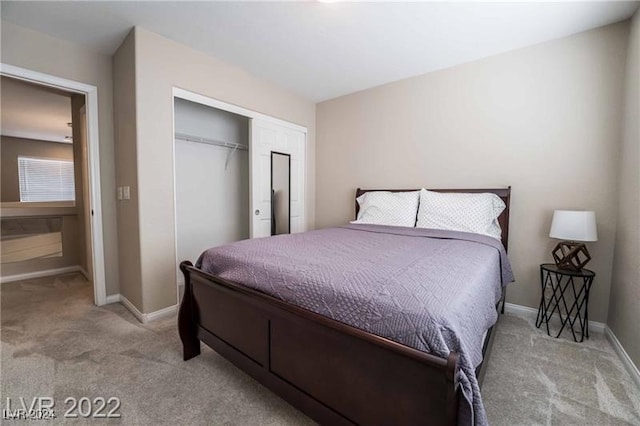 bedroom with a closet and light colored carpet