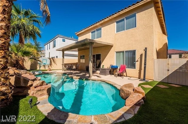 back of house featuring a fenced in pool and a patio