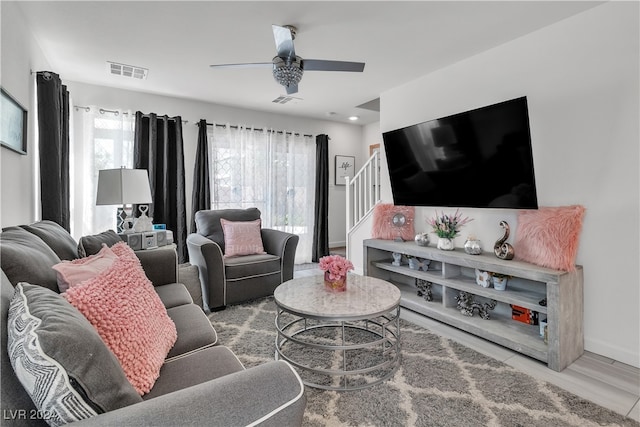 living room featuring ceiling fan and hardwood / wood-style flooring