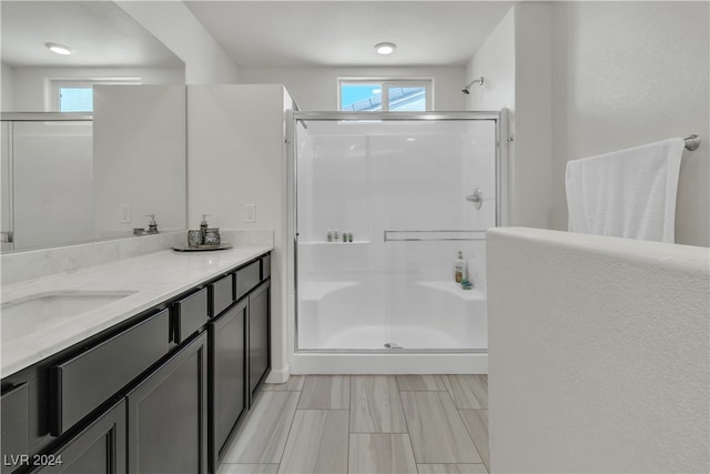 bathroom with walk in shower and vanity