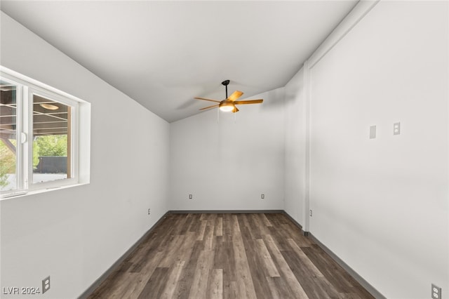 spare room with lofted ceiling, dark wood-type flooring, and ceiling fan