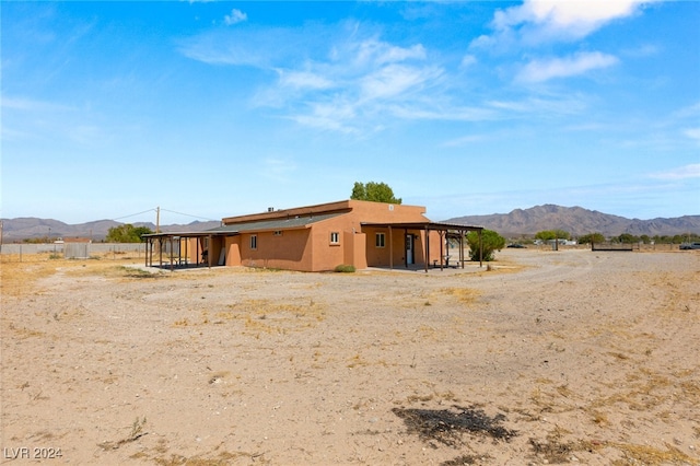 rear view of house with a mountain view and a rural view