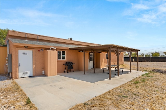 rear view of house featuring a patio and a pergola