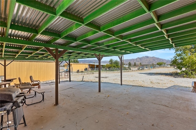 view of patio with area for grilling and a mountain view