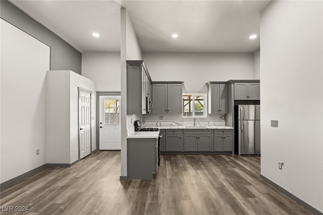 kitchen with gray cabinets, plenty of natural light, and stainless steel appliances