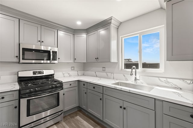 kitchen featuring gray cabinetry and appliances with stainless steel finishes