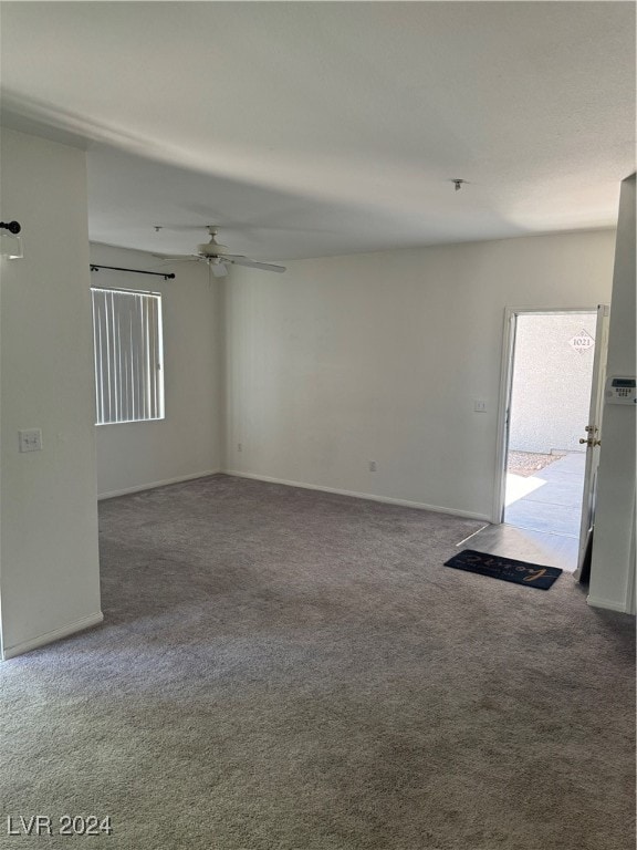 spare room with ceiling fan and carpet floors