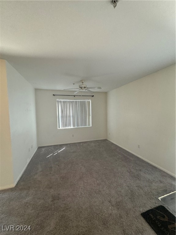 unfurnished room with ceiling fan and carpet