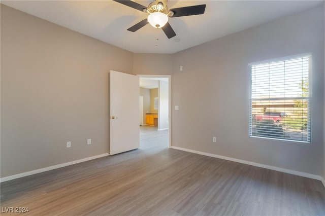 unfurnished room featuring dark hardwood / wood-style floors and ceiling fan