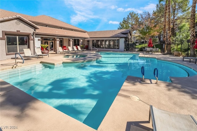 view of pool with a hot tub and a patio area