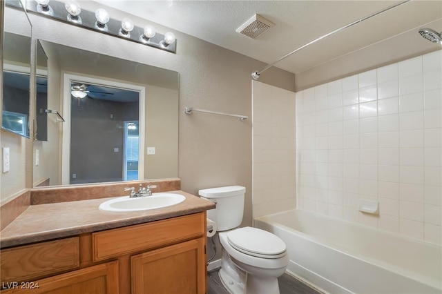 full bathroom with wood-type flooring, vanity, a textured ceiling, bathtub / shower combination, and toilet