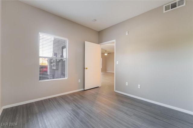 unfurnished room featuring dark wood-type flooring