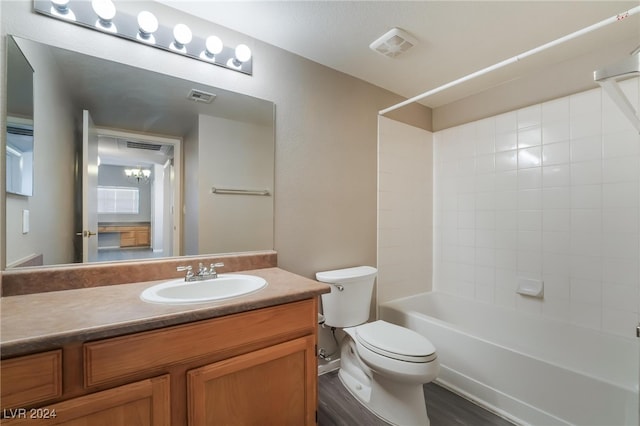 full bathroom featuring vanity,  shower combination, hardwood / wood-style floors, toilet, and a chandelier