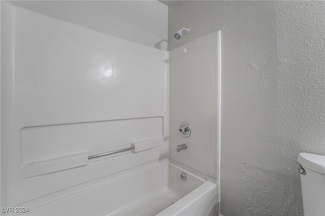 bathroom featuring bathing tub / shower combination and toilet