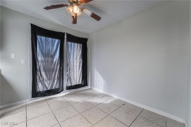 tiled empty room with a textured ceiling and ceiling fan