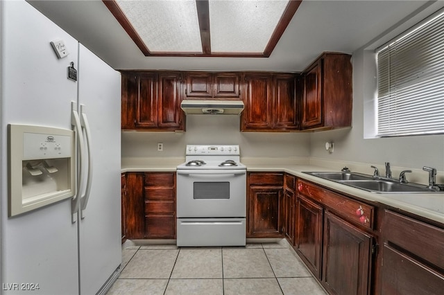 kitchen with white appliances, sink, and light tile patterned floors