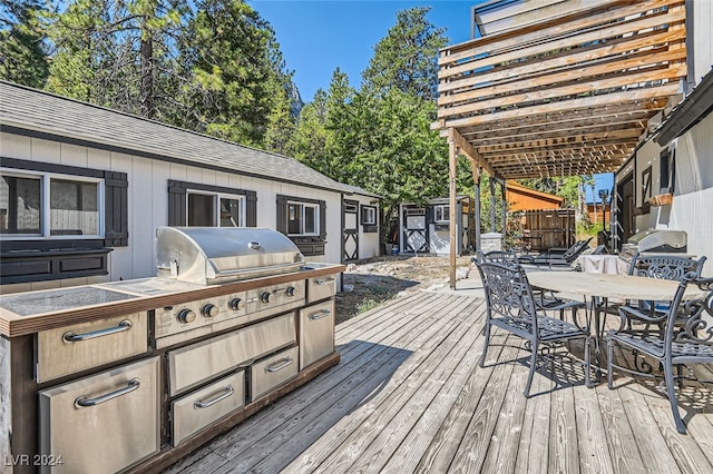 wooden terrace featuring exterior kitchen and grilling area