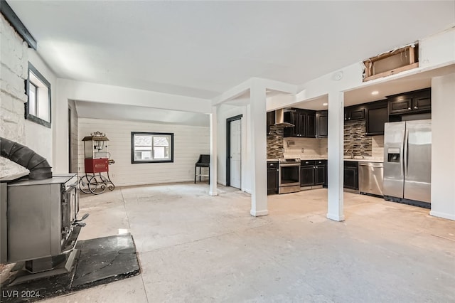 unfurnished living room featuring plenty of natural light and sink