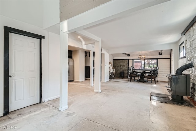 interior space with stainless steel fridge and a wood stove