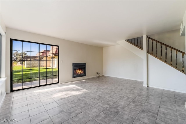 unfurnished living room with light tile patterned floors