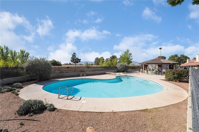 view of swimming pool with a gazebo and a patio area