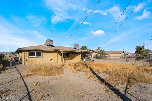 back of house featuring central AC