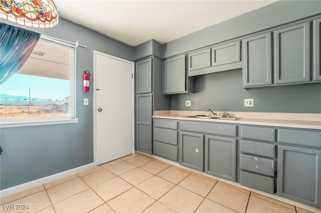 kitchen with light tile patterned floors and sink