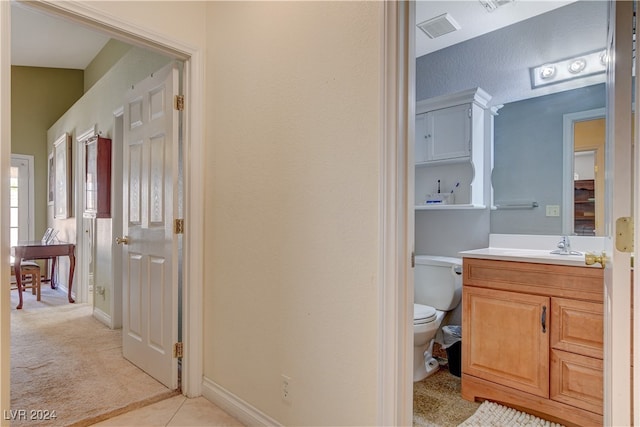 bathroom featuring vanity, toilet, and tile patterned floors