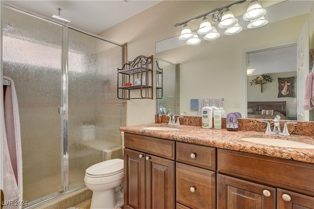 bathroom with tile patterned flooring, walk in shower, vanity, and toilet