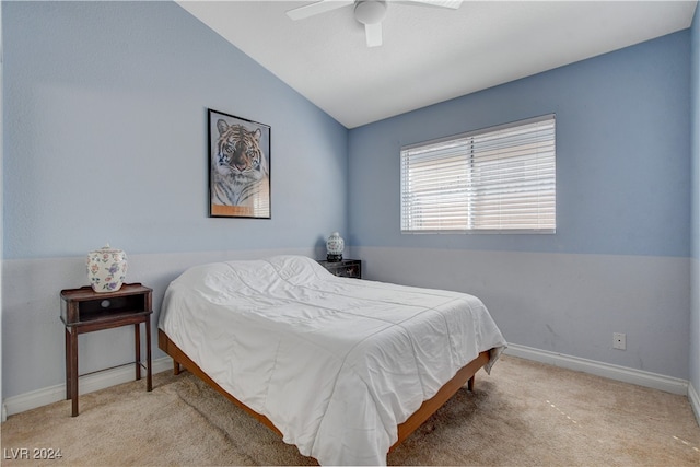 bedroom with vaulted ceiling, light carpet, and ceiling fan