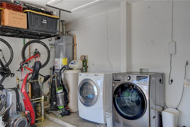 laundry room with washer and clothes dryer and water heater