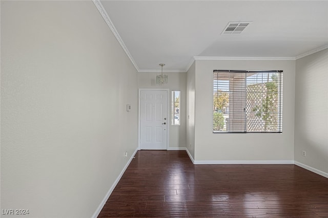 entrance foyer with crown molding, a notable chandelier, and dark hardwood / wood-style floors