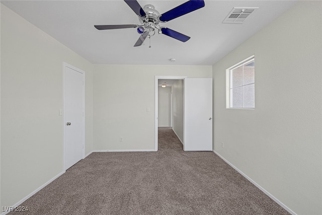 spare room featuring carpet floors and ceiling fan