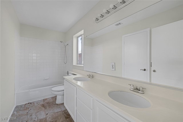 full bathroom with vanity, toilet, and tiled shower / bath