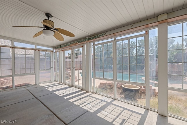 unfurnished sunroom featuring ceiling fan